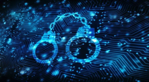 Digital handcuffs over a circuit board symbolizing the arrest and prosecution of a Nefilim ransomware affiliate.