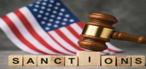 Judge’s gavel with U.S. flag symbolizing U.S. government sanctions decisions and policy review related to spyware actors.