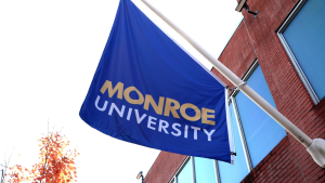 Monroe University campus flag outside academic building following confirmation of major data breach