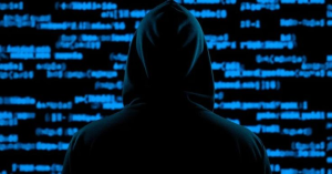 Hacker silhouette in front of code representing an unauthenticated remote code execution vulnerability targeting SmarterMail servers.