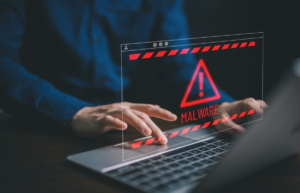 Malware warning displayed on laptop screen representing risk of visiting malicious website exploiting Chrome zero-day flaw.