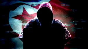 Silhouette of a hooded hacker with North Korea flag background representing UNC1069 cyber operations against crypto companies.