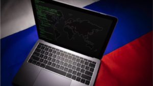 Laptop showing code and world map placed on the Russian flag symbolizing internet censorship and digital control in Russia.
