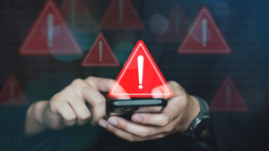 Android smartphone displaying security warning symbol representing mobile banking malware and financial cyber threats.