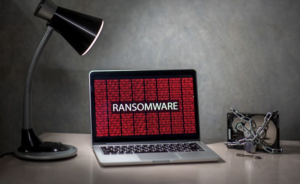Laptop screen displaying ransomware message indicating a cyberattack on university research systems.