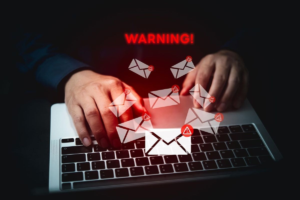 Phishing emails warning on laptop screen showing how Casbaneiro spreads through malicious emails